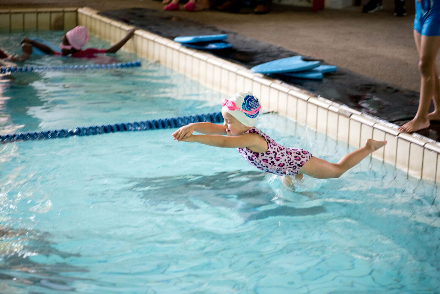 Young swimmer diving into a Kiddies Aqua heated indoor pool