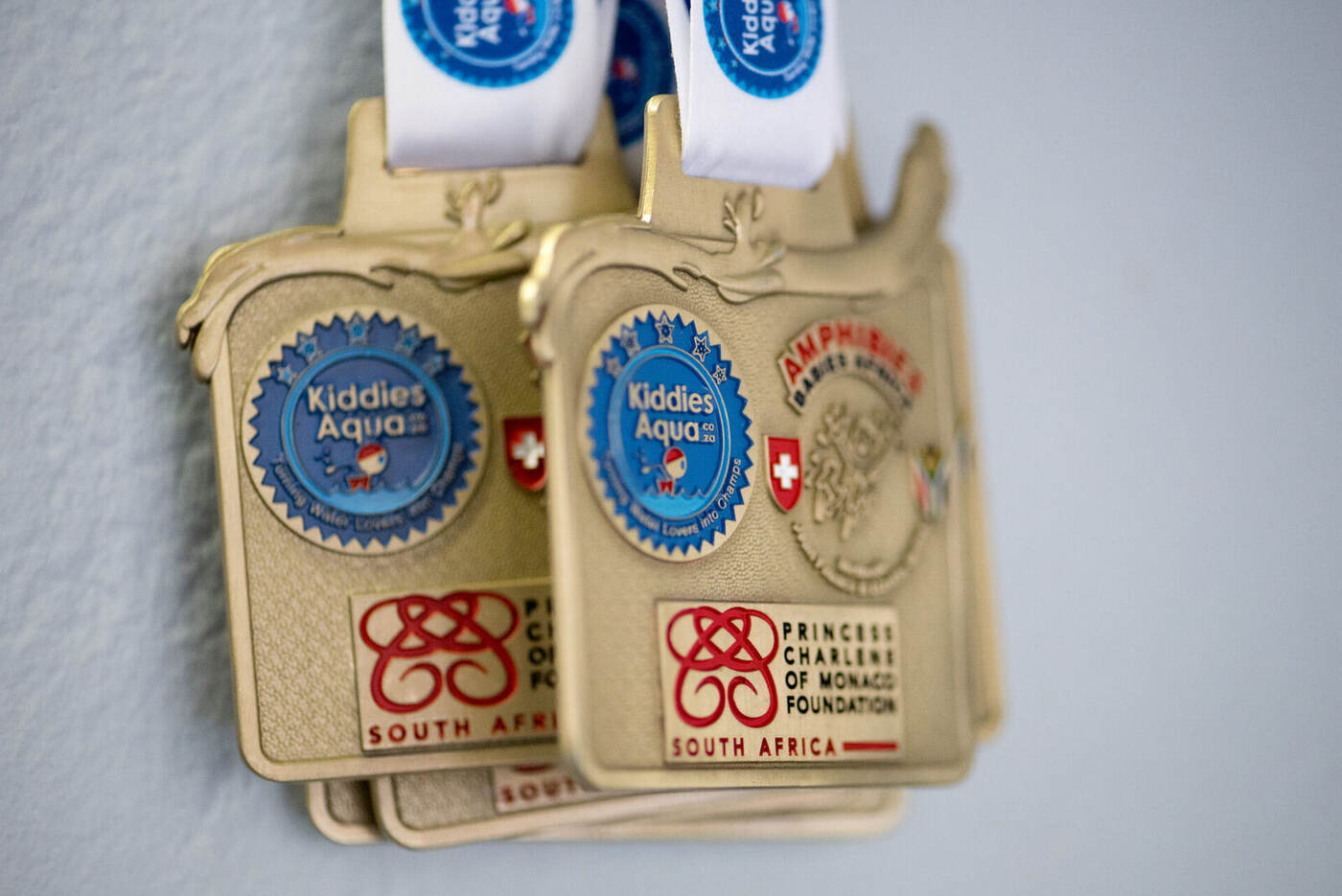 Kiddies Aqua achievement medals displayed at a swim school awards moment