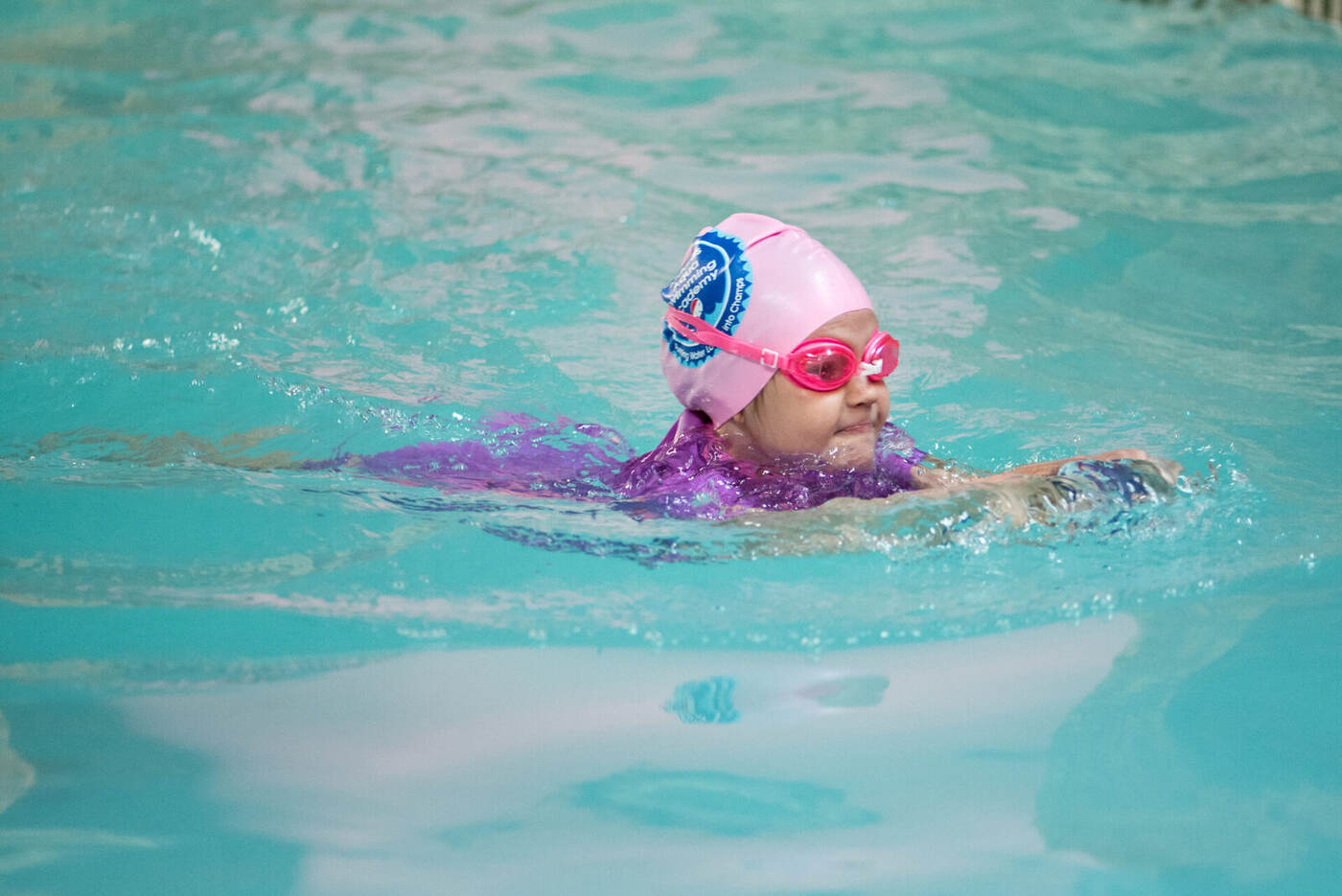 Young swimmer practising freestyle towards the camera at a Kiddies Aqua pool