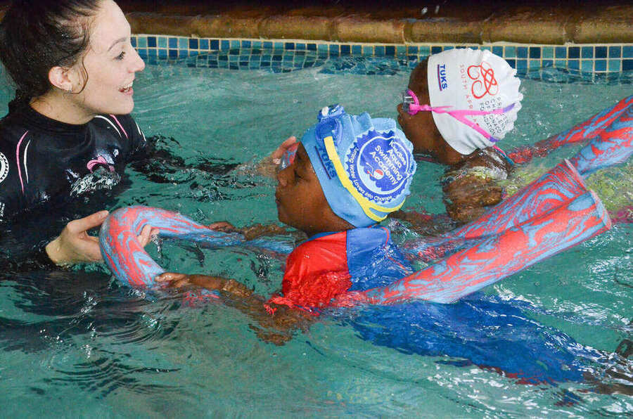 Kiddies Aqua instructor coaching a young swimmer on stroke technique