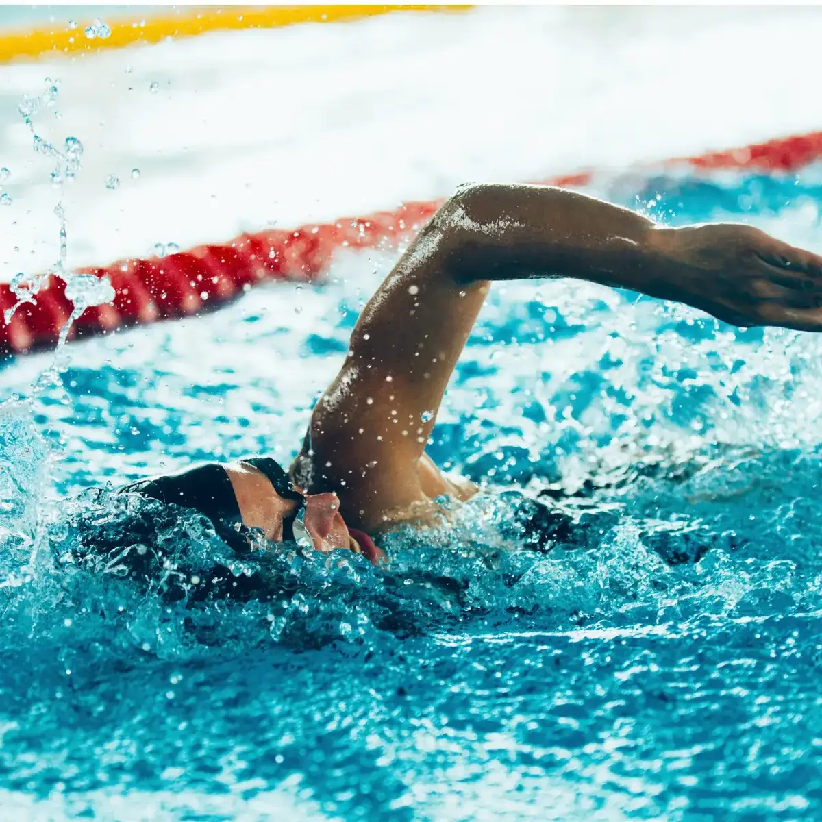 Close-up of a swimmer's freestyle arm recovery and clean catch during a stroke-correction session