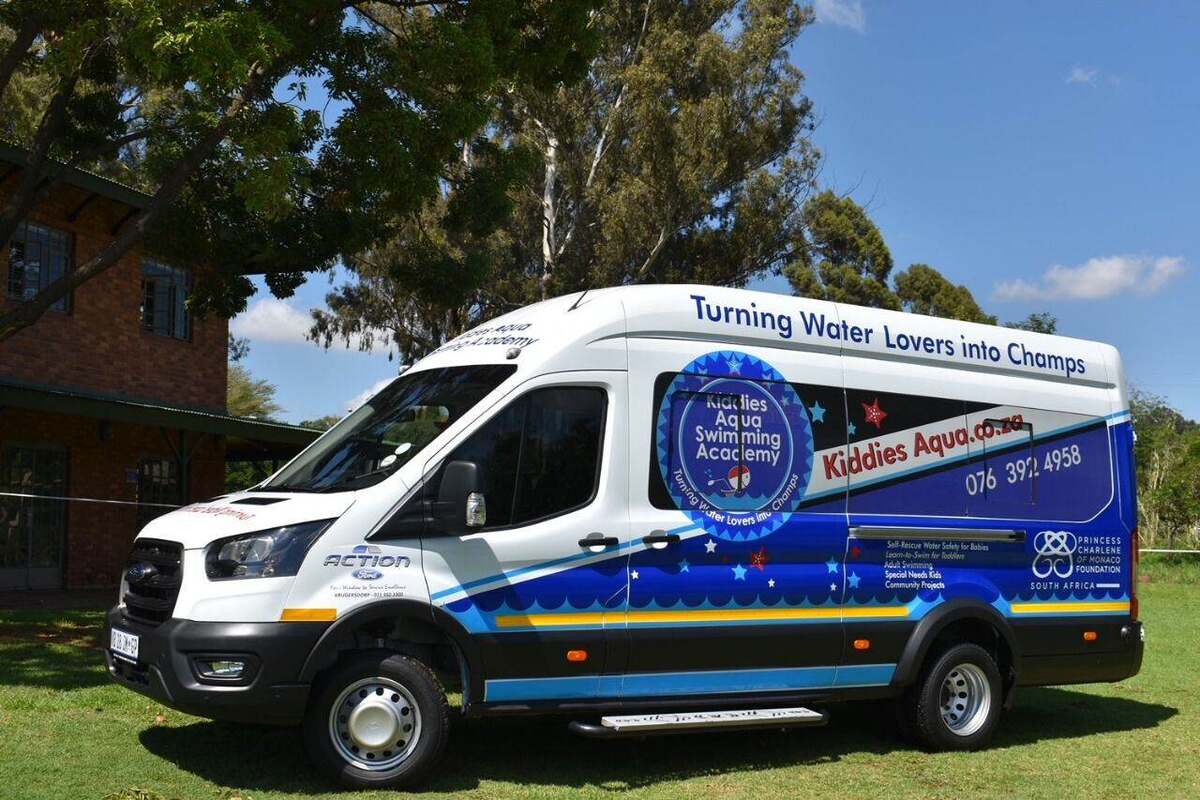 A Kiddies Aqua luxury swim-school transport bus branded 'Turning Water Lovers into Champs'