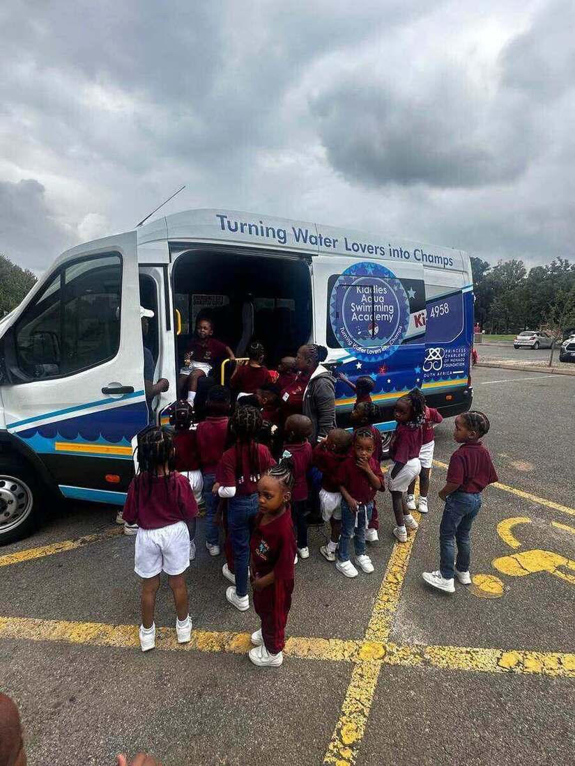 School learners in uniform boarding a Kiddies Aqua swim-school bus for their weekly swimming lesson