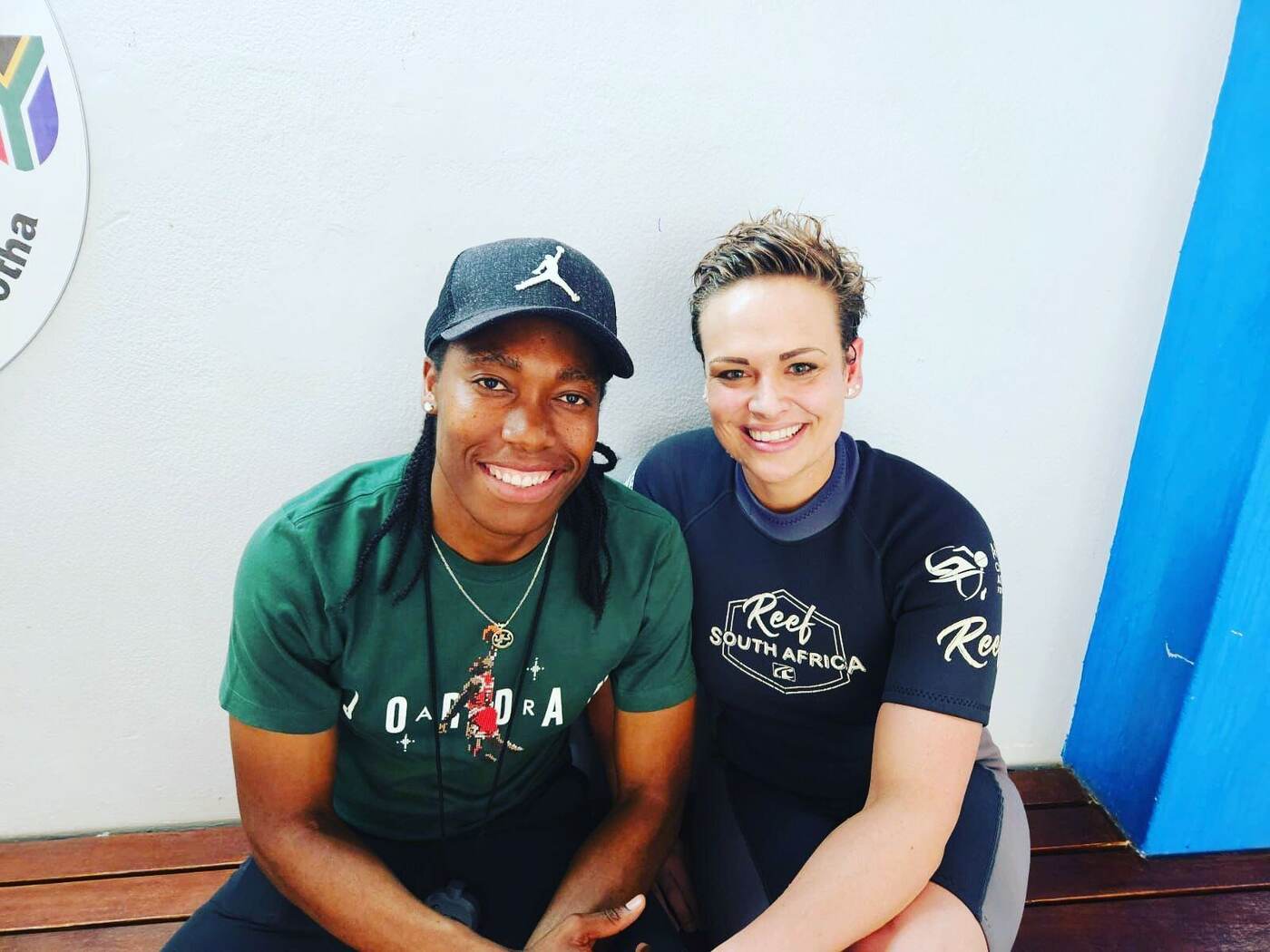 Olympic 800m champion Caster Semenya seated with her Kiddies Aqua Reef South Africa swimming instructor